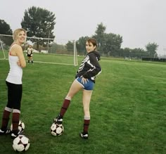 two women are playing soccer on the field