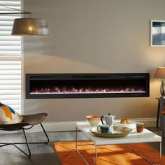 a living room with a couch, coffee table and fire place in front of the fireplace