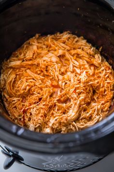 shredded carrots in the crock pot ready to be cooked and put into the slow cooker