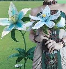 a woman holding flowers in her hands and posing for the camera with green grass behind her