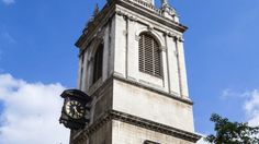 a tall tower with a clock on the side of it's face and sky in the background