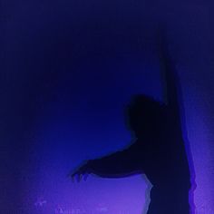 the silhouette of a person on a skateboard in front of a purple background with blue lights