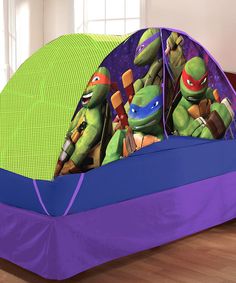 two teenage mutant ninja turtles in a purple and green tent on the floor next to each other