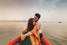 a man and woman in a boat on the water