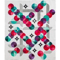 a white quilt with colorful circles on it