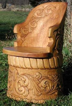 a carved wooden chair sitting in the grass