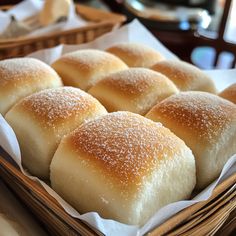 bread rolls in a basket on a table