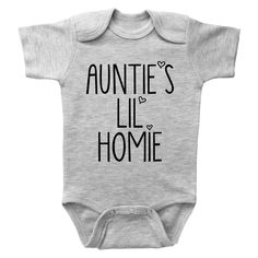 AUNTIE'S LIL HOMIE - Basic Onesie This is one of the cutest aunt onesies in our entire collection. This aunt themed onesie for baby boys or baby girls makes an amazing onesie gift for a baby shower or just because. Style Options: Short Sleeve White, Long Sleeve White, Short Sleeve Grey, Long Sleeve Grey Size Options: Newborn, 0-3m, 3-6m, 6-12m, 12-18m, 18-24m This onesie features a funny aunt themed saying and makes the perfect gift for any new aunt. Grab yours today, sizes from Newborn up to 24 Gender Reveal Onesie With Letter Print, Personalized Cotton Onesie, Personalized Unisex Cotton Onesie, Customizable Cotton Onesie For Father's Day, Cute Unisex Onesie With Name Print, Funny Mother's Day Onesie With Letter Print, Baby Onsies Ideas Funny, Aunt Onesie, Cute Baby Onesies