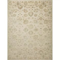 a beige rug with an ornate design on the top and bottom, in different colors