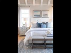 a bedroom with white furniture and blue accents