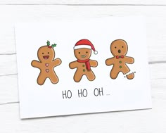 three gingerbreads with santa hats on and the words ho hoo oh