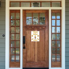 the front door of a house with two sidelights on either side and one light on