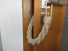 a rope wrapped around a door handle on a wooden door