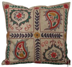 an embroidered pillow with decorative designs on it