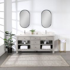 a bathroom with two mirrors above the sink and rug on the floor next to it