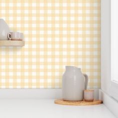 two white vases sitting on top of a shelf next to a window sill