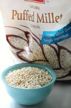 a blue bowl filled with cereal next to a bag of pureed millets on a counter