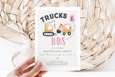 a person holding up a card with a truck on it and the words trucks are in pink