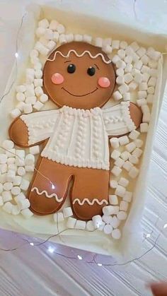 a gingerbread man is sitting in the middle of marshmallows