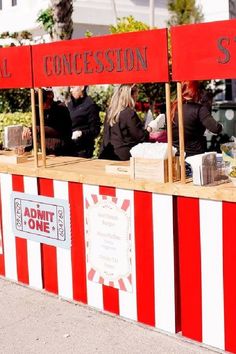 an outdoor food stand with red and white stripes