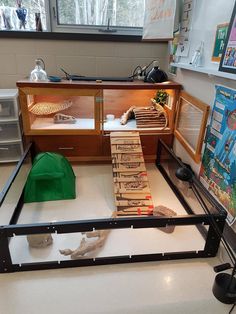 a display case filled with lots of boxes and papers on top of a white floor