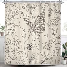 a shower curtain with an image of a butterfly and flowers on it, next to a potted plant