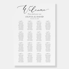 a white wedding seating chart with black calligraphy on the front and bottom, which reads welcome