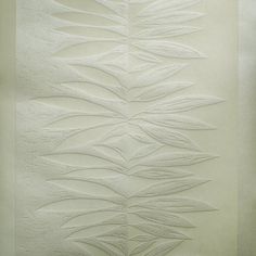 an artisticly designed wall panel with leaves on it