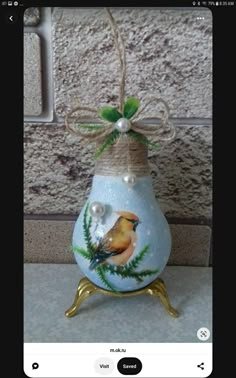 a vase with a bird painted on it and a bow tied to the top is shown