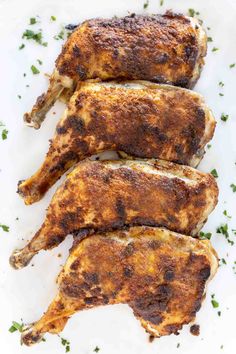 crispy baked chicken leg quarters on a white plate