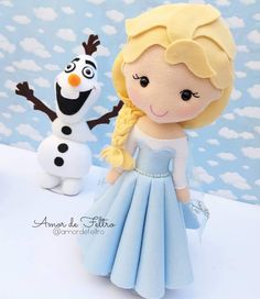 a close up of a stuffed animal with a snowman and frozen princess doll in the background