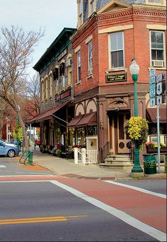 a street corner with cars parked on the side