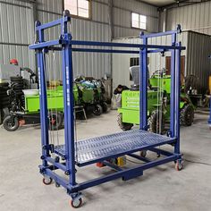 two green and blue tractors in a warehouse