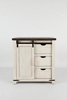 a white cabinet with four drawers and two doors