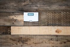 a digital clock sitting on top of wooden planks