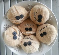 a white plate topped with lots of brown balls of yarn covered in fake faces and eyes