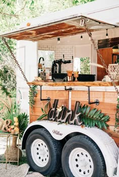 a food truck is decorated with greenery and letters