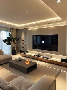 a living room with white couches and a flat screen tv mounted on the wall