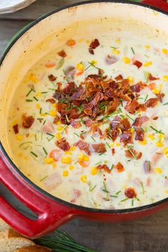 a red pot filled with corn and bacon soup