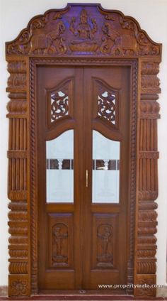 an ornate wooden door with glass panels