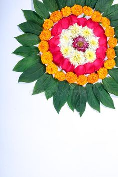 an arrangement of flowers arranged in the shape of a sunflower on a white background