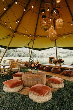 the inside of a large tent with chairs and tables