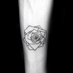 a black and white photo of a rose tattoo on the left inner arm, with an outline in the middle