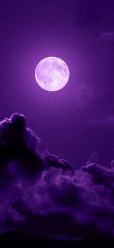 the full moon is shining brightly in the purple sky above some dark clouds and mountains