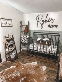 a baby crib in the corner of a room with a rug on the floor