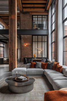 a living room filled with lots of furniture and tall windows in it's walls