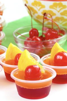 small plastic cups filled with jelly and cherries