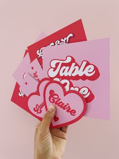 someone holding up some valentine's day cards with the word table time on them