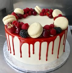 a cake with berries, raspberries and cookies on top