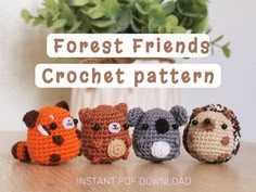 four crocheted animals sitting on top of a table next to a potted plant